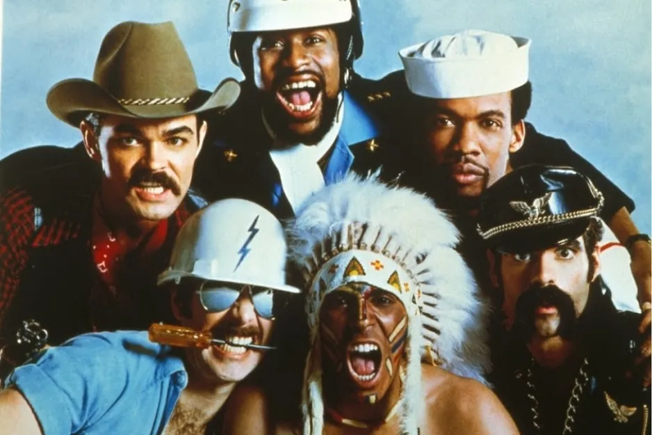 The Village People dressed in iconic costumes posing together for a disco era promotional photo.