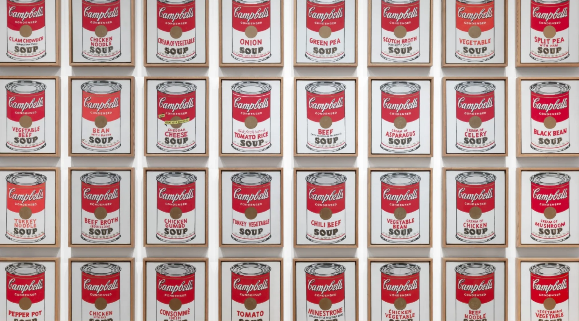 Framed colorful Campbell’s soup cans artwork, iconic pop art image influential in 1970s pop culture knowledge.