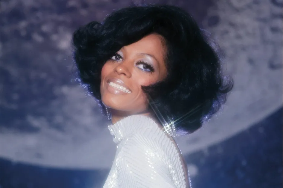 Diana Ross smiling in a sparkly dress with voluminous hair, known as the queen of disco with the hit Hot Stuff.