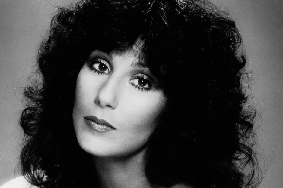Black and white portrait of Cher, the famous Queen of Disco known for her hit Hot Stuff, looking directly at the camera.