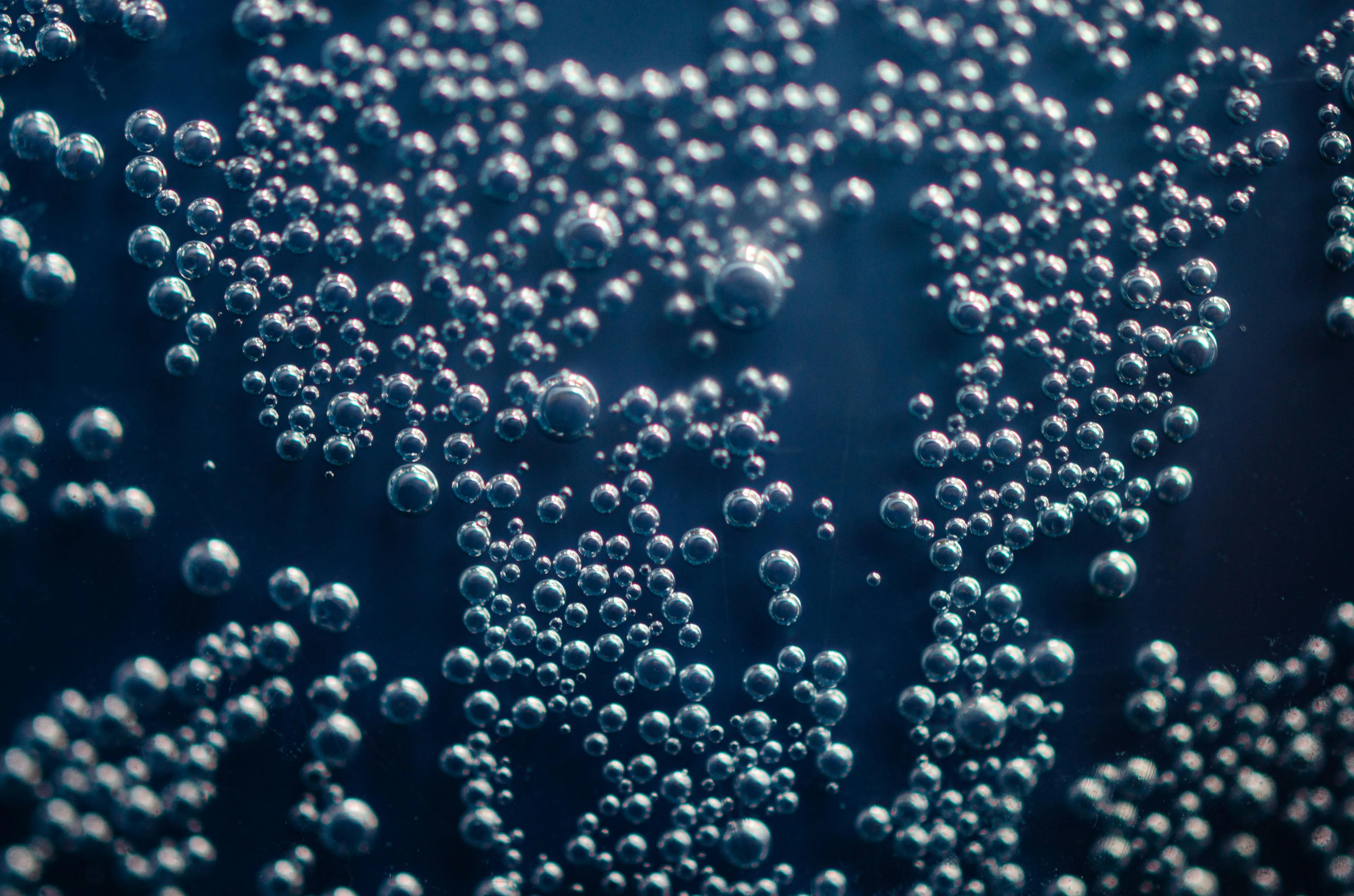 Close-up of gas bubbles underwater illustrating a GCSE Combined Science quiz on complete combustion of hydrocarbons.