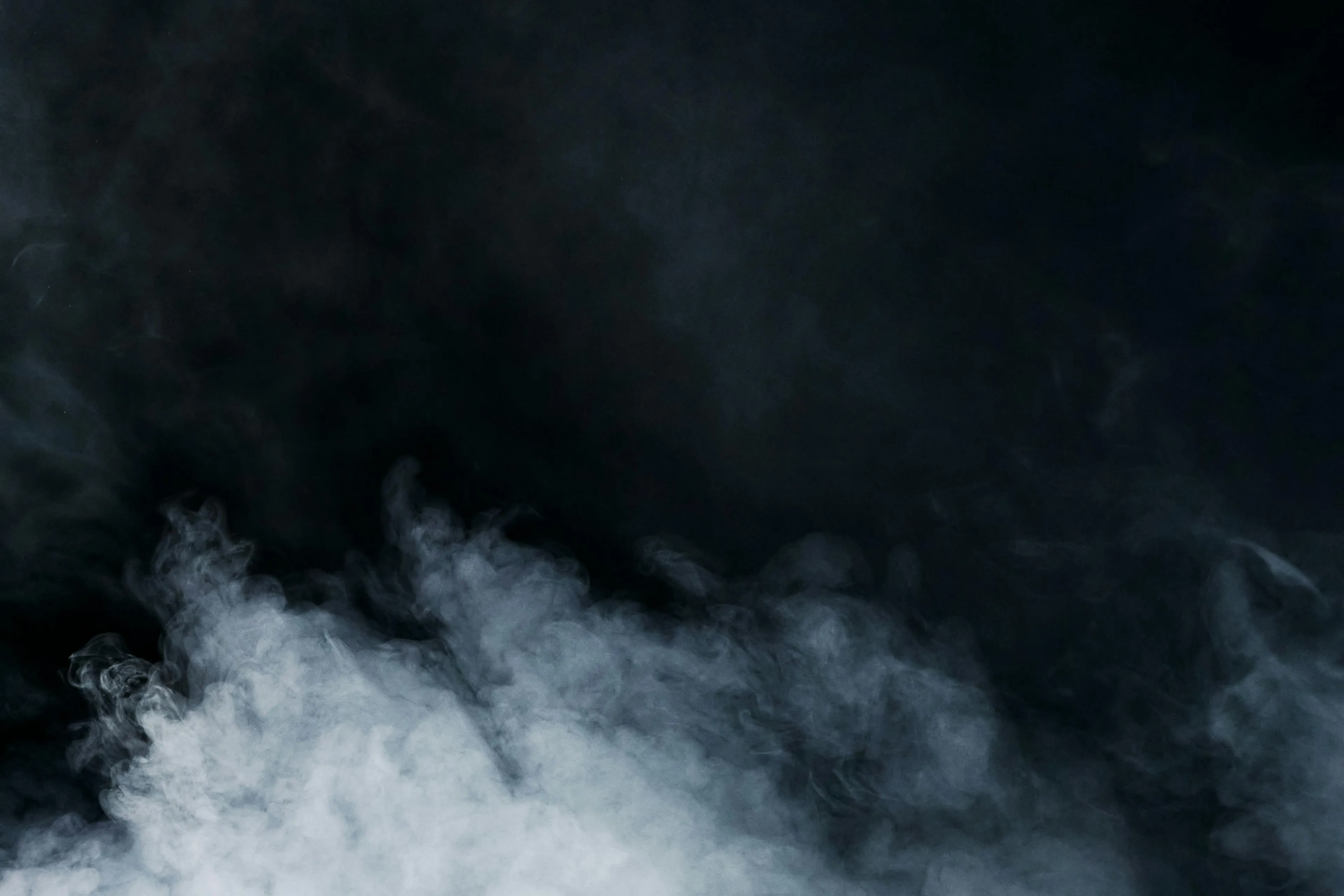 Dense white smoke swirling against a dark background representing elements in a GCSE Combined Science Quiz about noble gases.