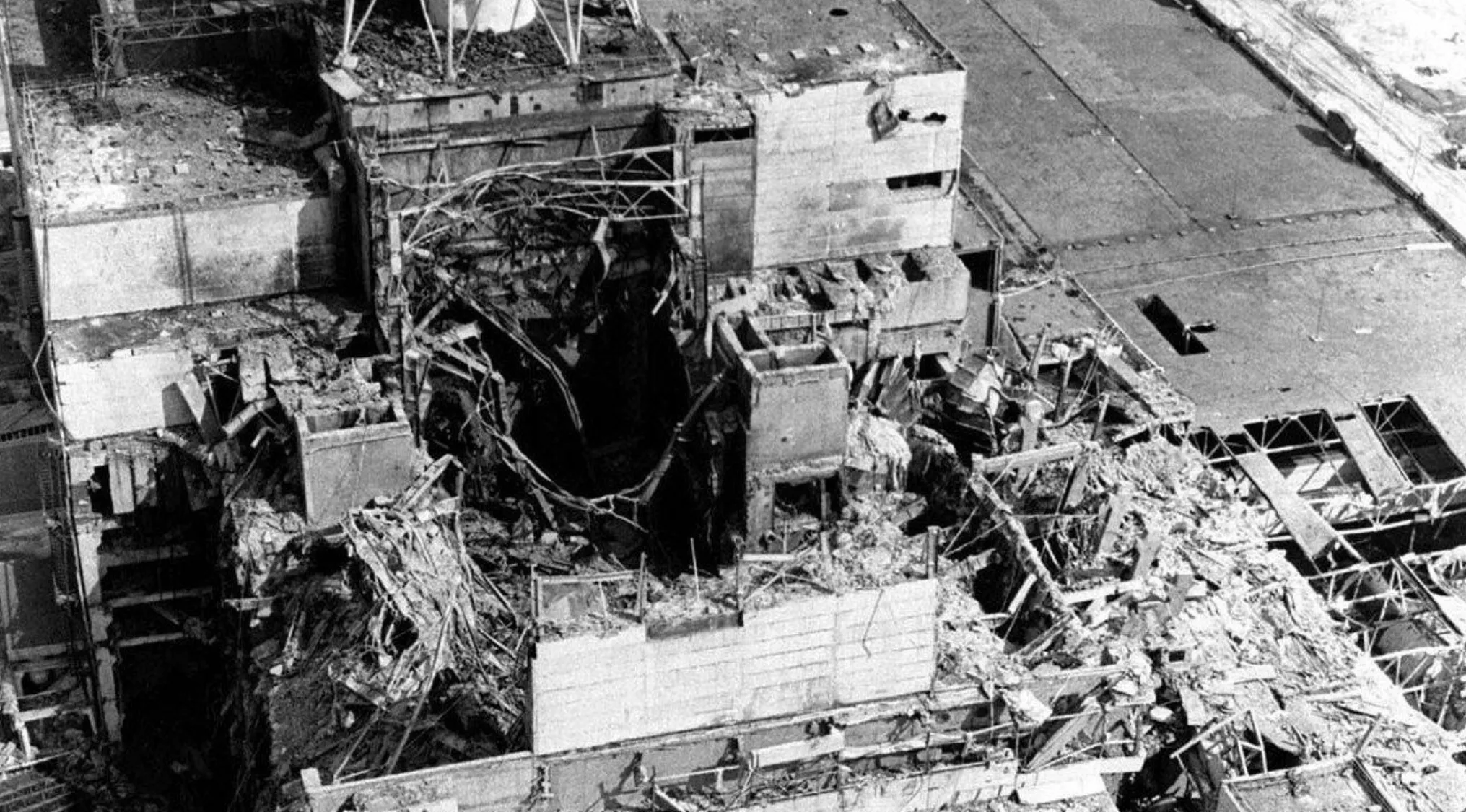 Aerial view of the destroyed reactor building showing damage from the Chernobyl nuclear disaster event.