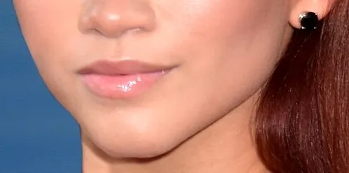 Close-up of a celebrity mouth and teeth showing glossy lips and smooth skin for Guess The Celebrity From Their Mouth.