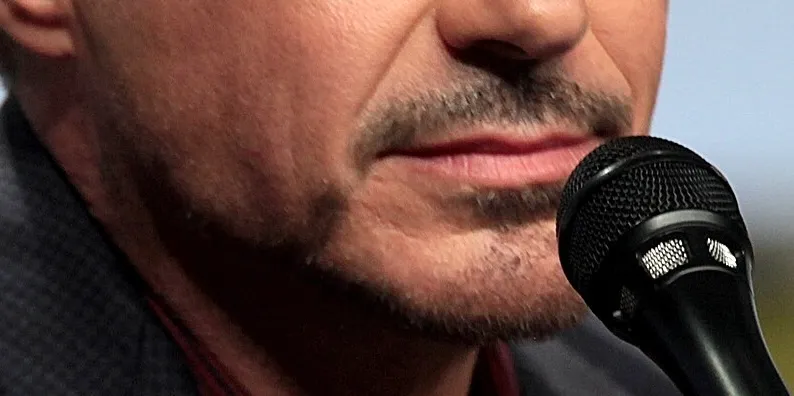 Close-up of a celebrity mouth speaking into a microphone for guess the celebrity from their mouth challenge.