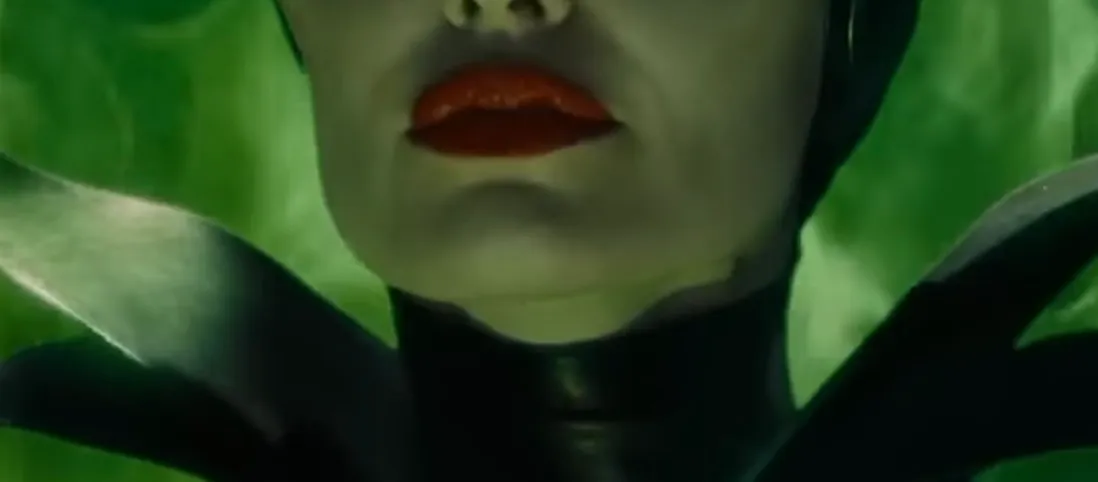 Close-up of a celebrity mouth with dark red lips and black costume details in the guess the celebrity from their mouth challenge.