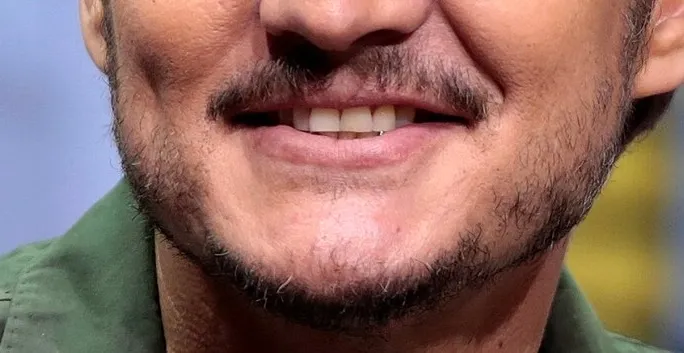 Close-up of a celebrity's mouth with a trimmed mustache and beard, part of guess the celebrity from their mouth game.
