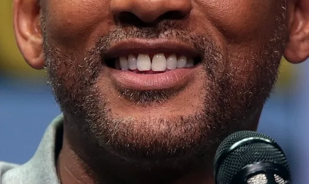 Close-up of a celebrity mouth and smile with beard, part of the guess the celebrity from their mouth series.