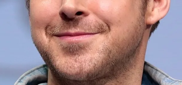 Close-up of a male celebrity’s mouth and partial beard for guess the celebrity from their mouth game.