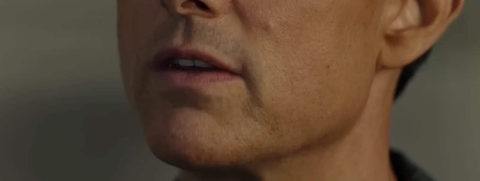 Close-up of a male celebrity's mouth showing a subtle smile for guess the celebrity mouth challenge part 3.