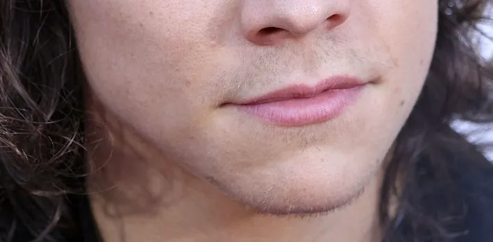 Close-up of a celebrity's mouth and chin with light stubble, part of the Guess The Celebrity from Their Mouth challenge.