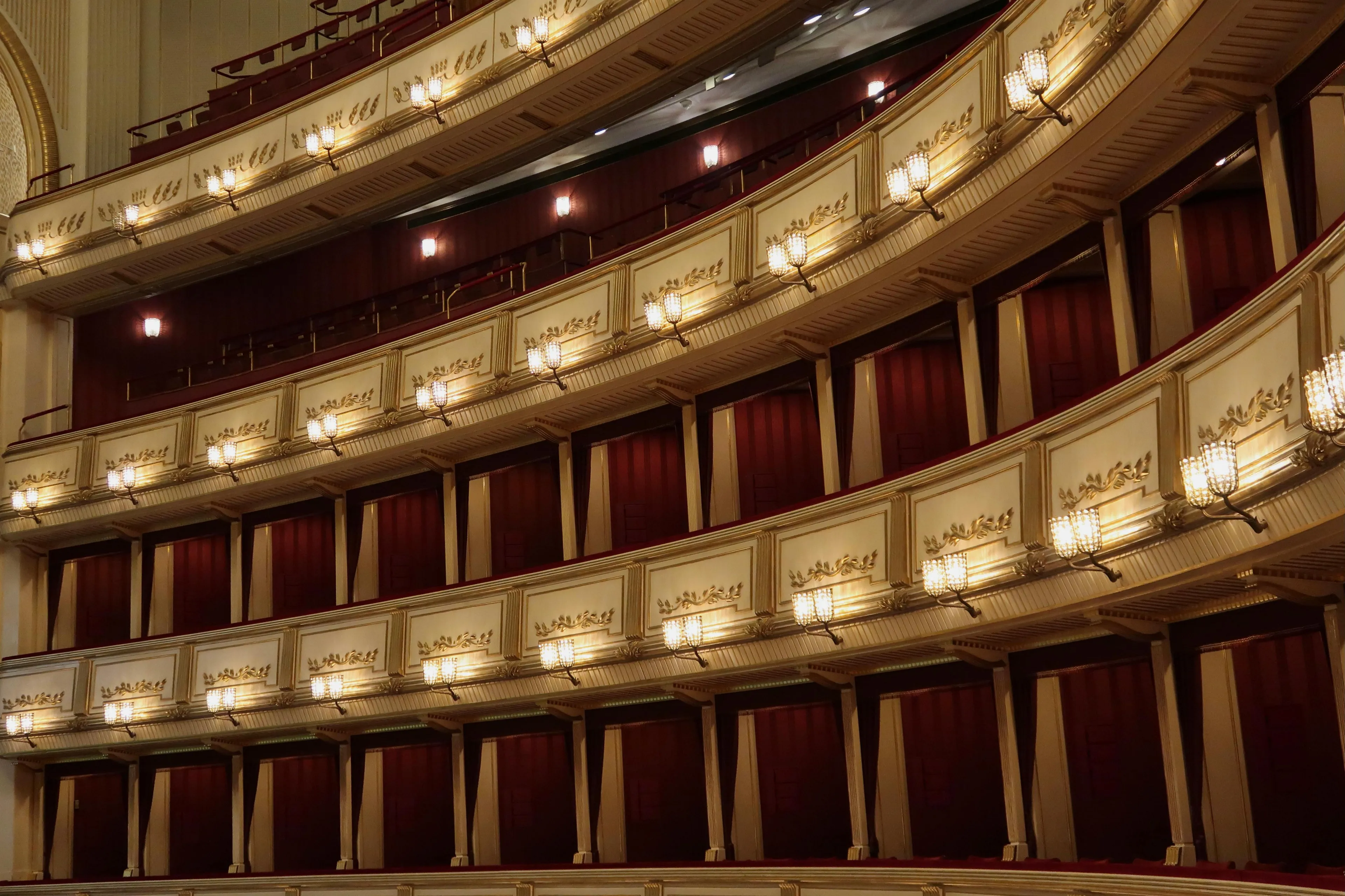 Opera house balconies with elegant lighting and red velvet curtains, related to the composer of The Magic Flute.