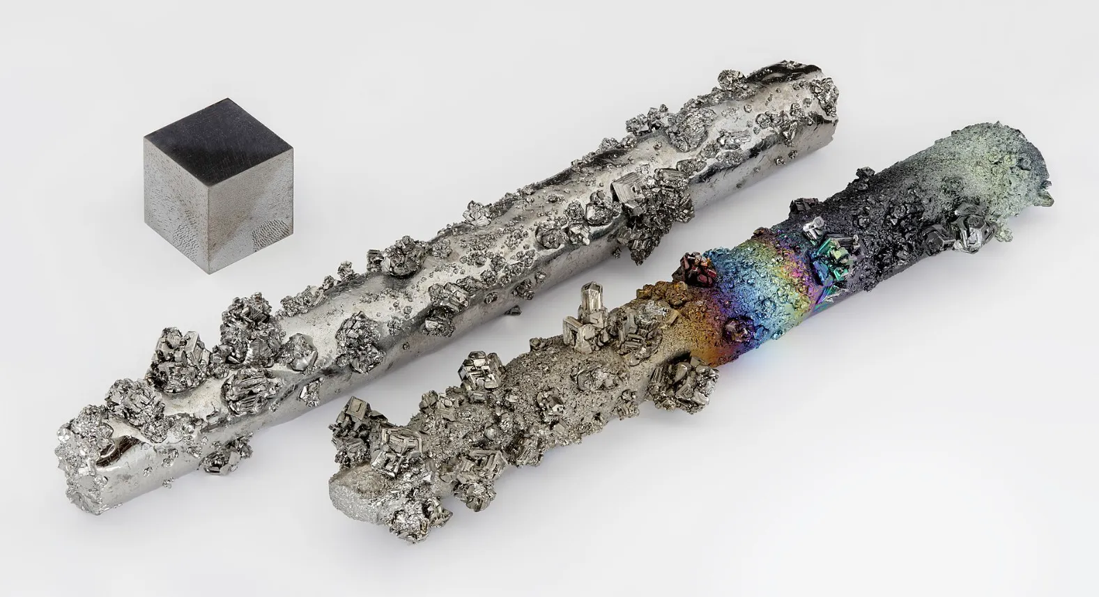 Close-up of tungsten metal samples showing rough and smooth textures representing the chemical symbol W element.
