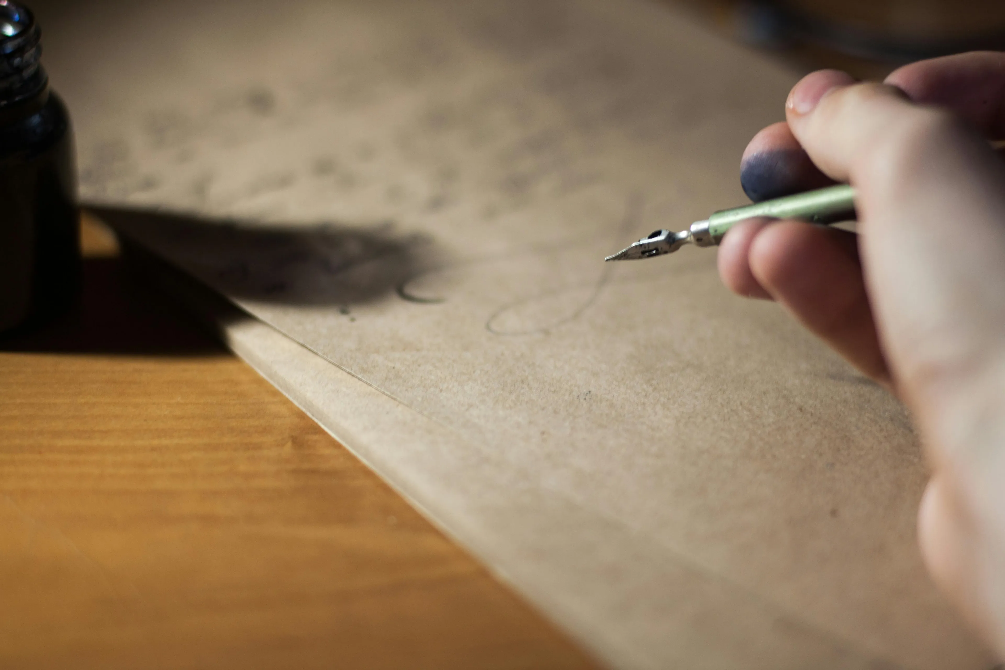 Hand holding a vintage fountain pen writing on parchment paper, relating to the treaty that ended World War I quiz.