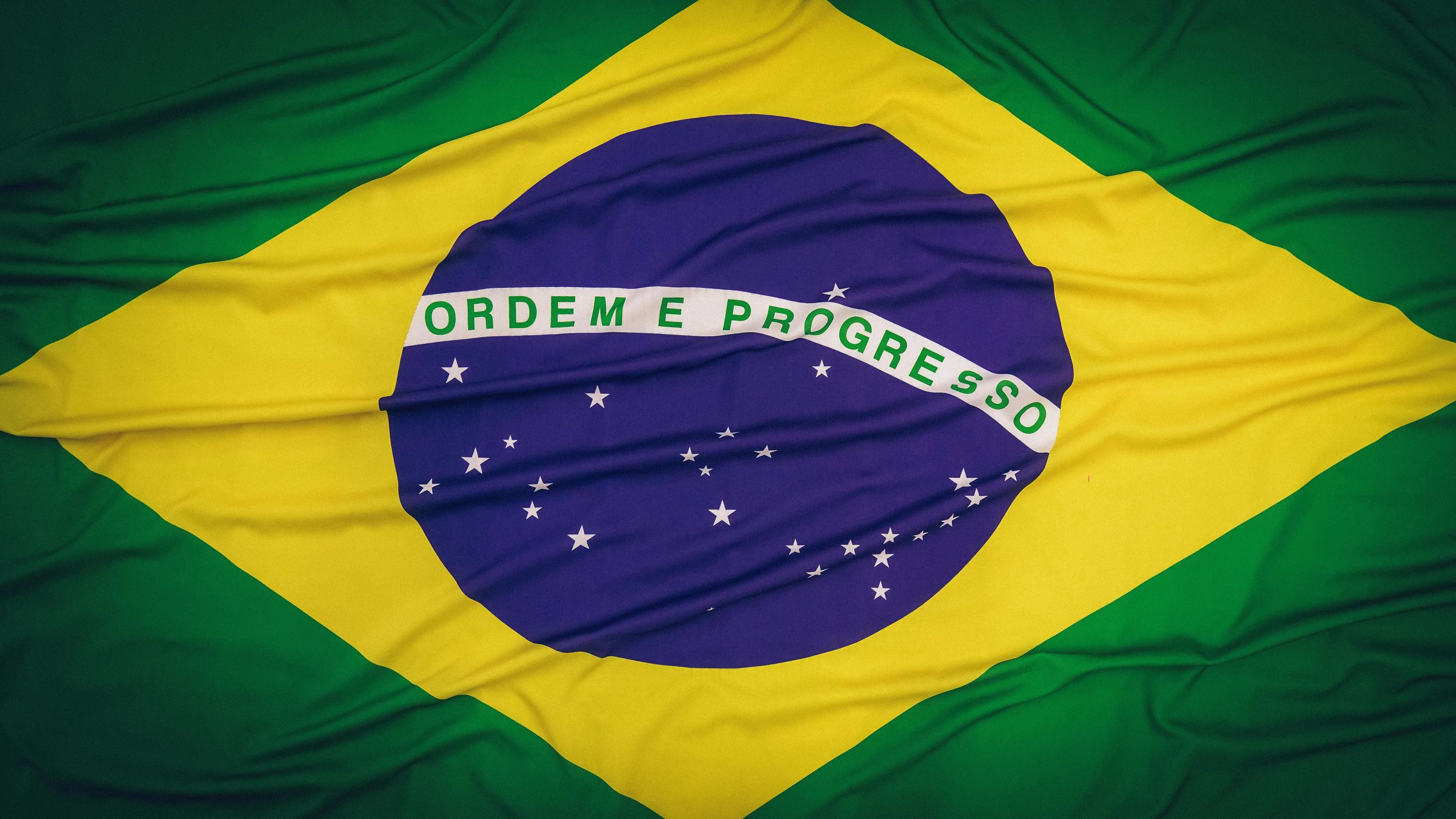 Brazil flag waving, symbolizing the official language of Brazil in a difficult general knowledge quiz for high IQs.