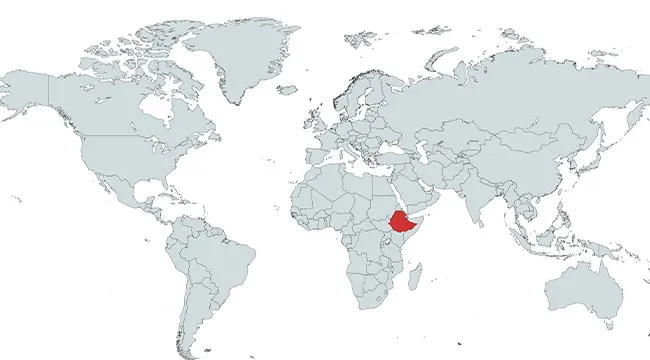 Map highlighting the country of Ethiopia in red within the African continent on a world map.