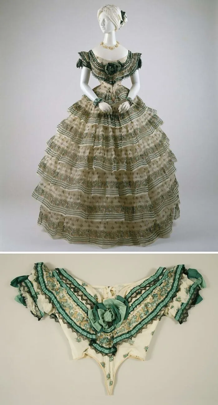 Victorian historical garment with floral patterns and green lace detailing displayed on a mannequin with matching bodice.