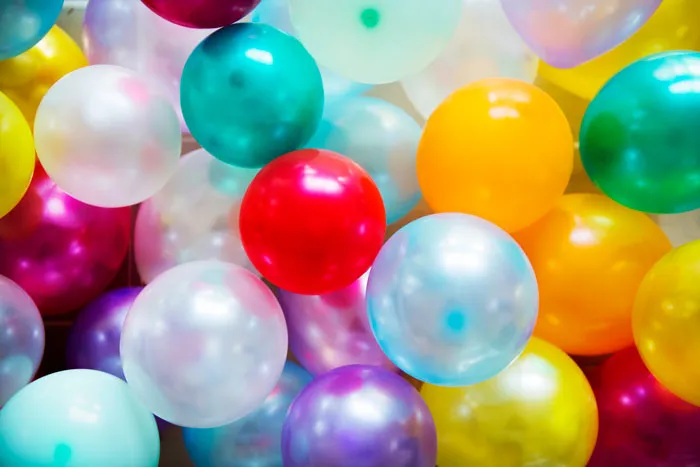Colorful balloons clustered together representing healthcare workers reflecting on things they will never do after experience.