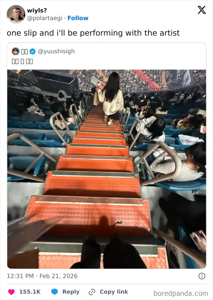 View from top of a steep stadium staircase with people seated, illustrating chaotic and hilarious X posts humor coping.