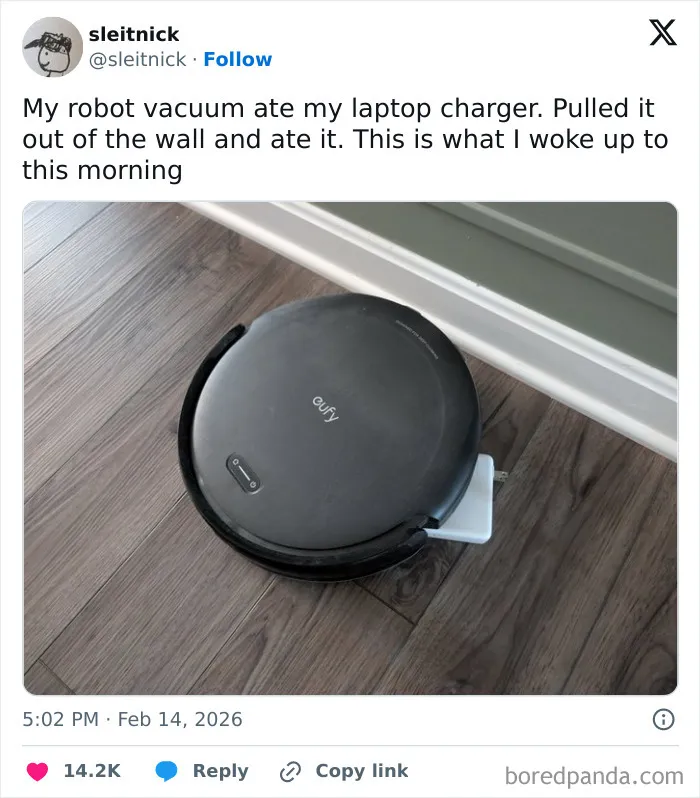 Robot vacuum on wooden floor with laptop charger stuck, illustrating chaotic and hilarious X posts humor coping in February.