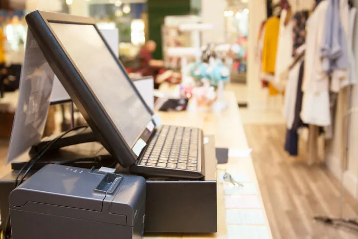 Point of sale system and receipt printer on a counter in a retail store setting during a graveyard shift.