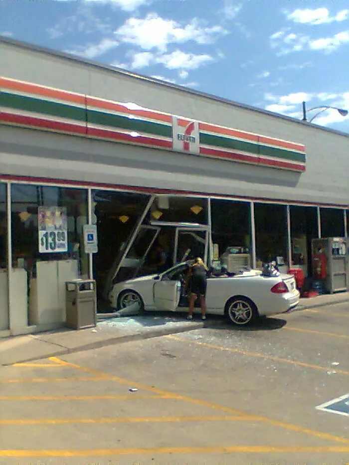 White convertible crashed through glass window of 7-Eleven convenience store, a scene graveyard shift workers often find confusing and scary.