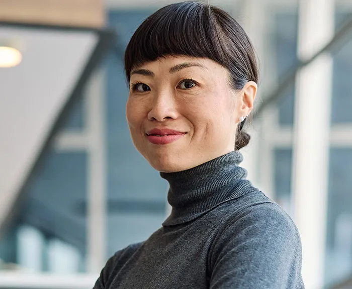 Professional woman coworker with a confident smile in an office setting representing coworkers who became legends for wrong reasons.