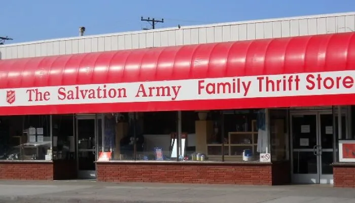 The Salvation Army Family Thrift Store storefront with red awning under clear blue sky, highlighting thrift store shopping.