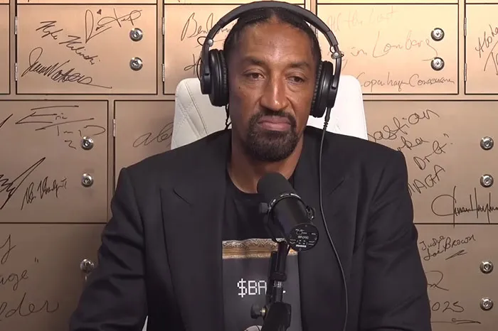 Man wearing headphones and speaking into a microphone during a podcast discussing Beyoncé and celebrities who lost fans.