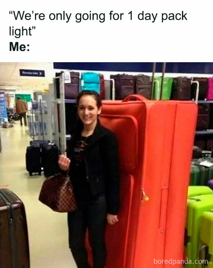 Woman smiling next to an oversized orange suitcase in a luggage store, illustrating hilarious travel memes about packing light.