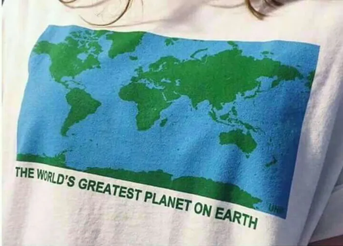 T-shirt with a world map graphic and text saying the world's greatest planet on earth, geography humor concept.
