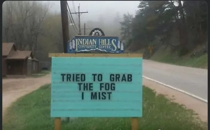 Humorous community center sign with a pun about fog, offering memes to lighten your mood when everything is annoying.