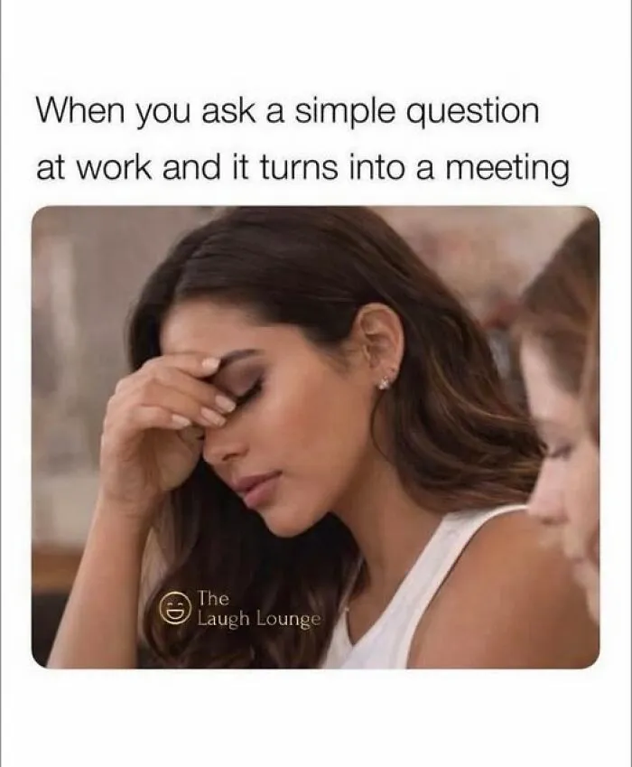 Woman with hand on forehead looking frustrated at work, illustrating an annoying moment to lighten mood with memes.