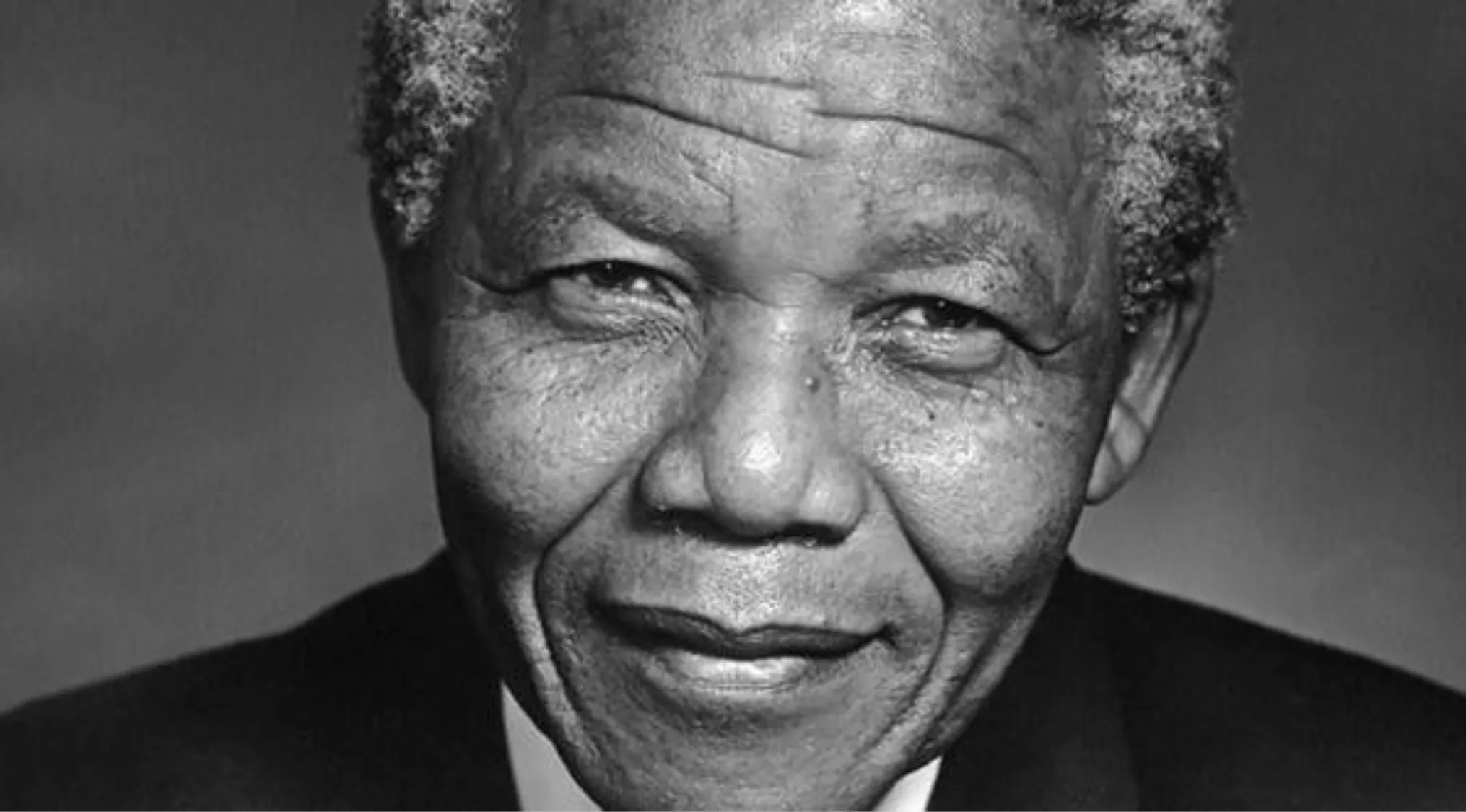 Portrait of the South African leader who spent 27 years in prison before becoming president, smiling gently.