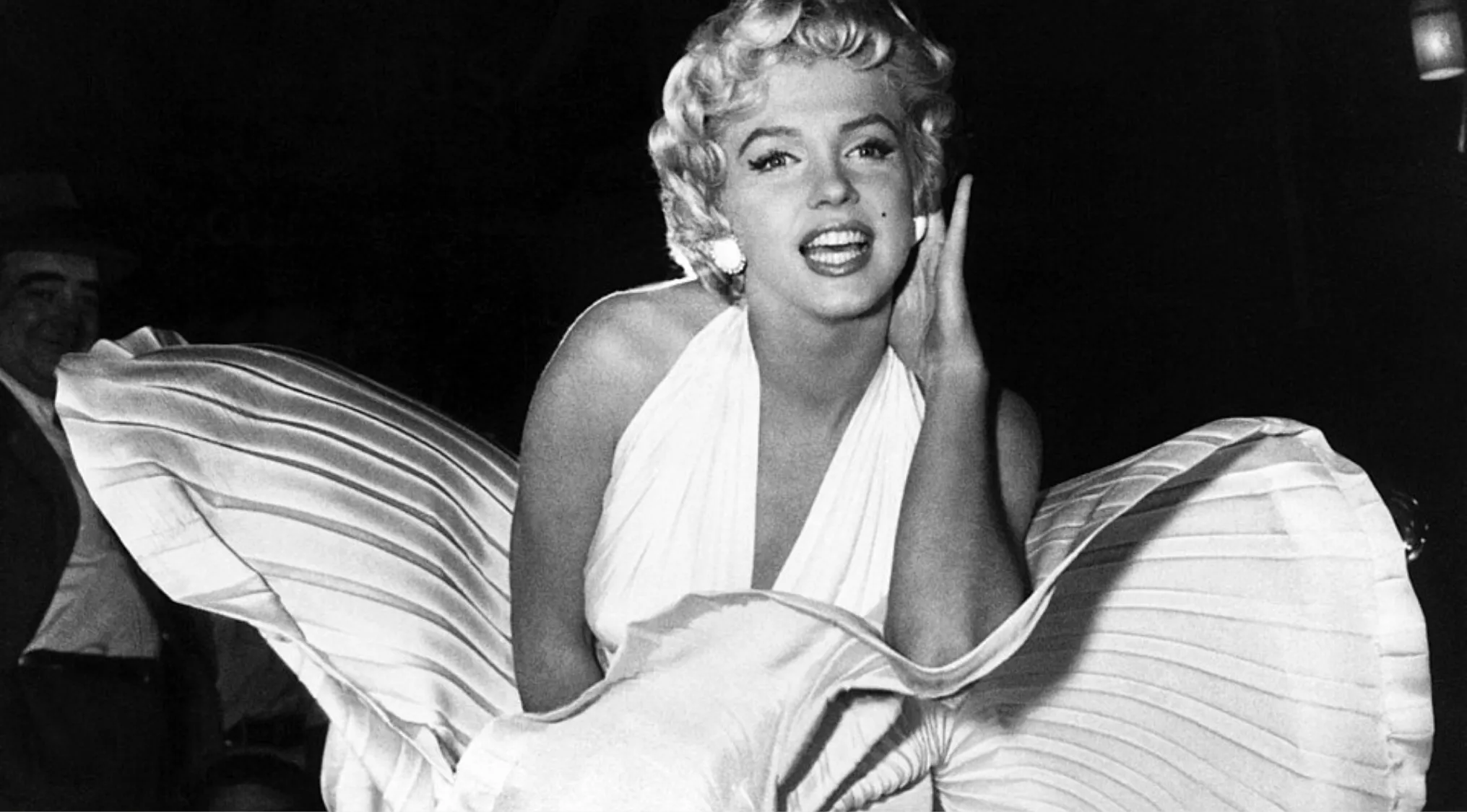 Hollywood actress Marilyn Monroe posing in a white dress, becoming one of the biggest icons of the 1950s.