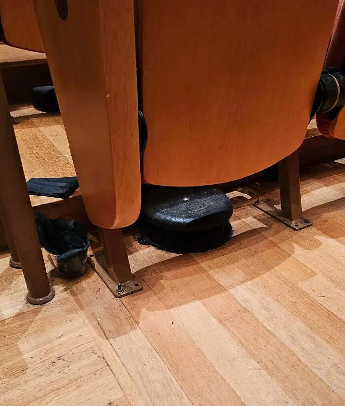 What Are These Metal Discs Under Many Seats At A Concert Hall?