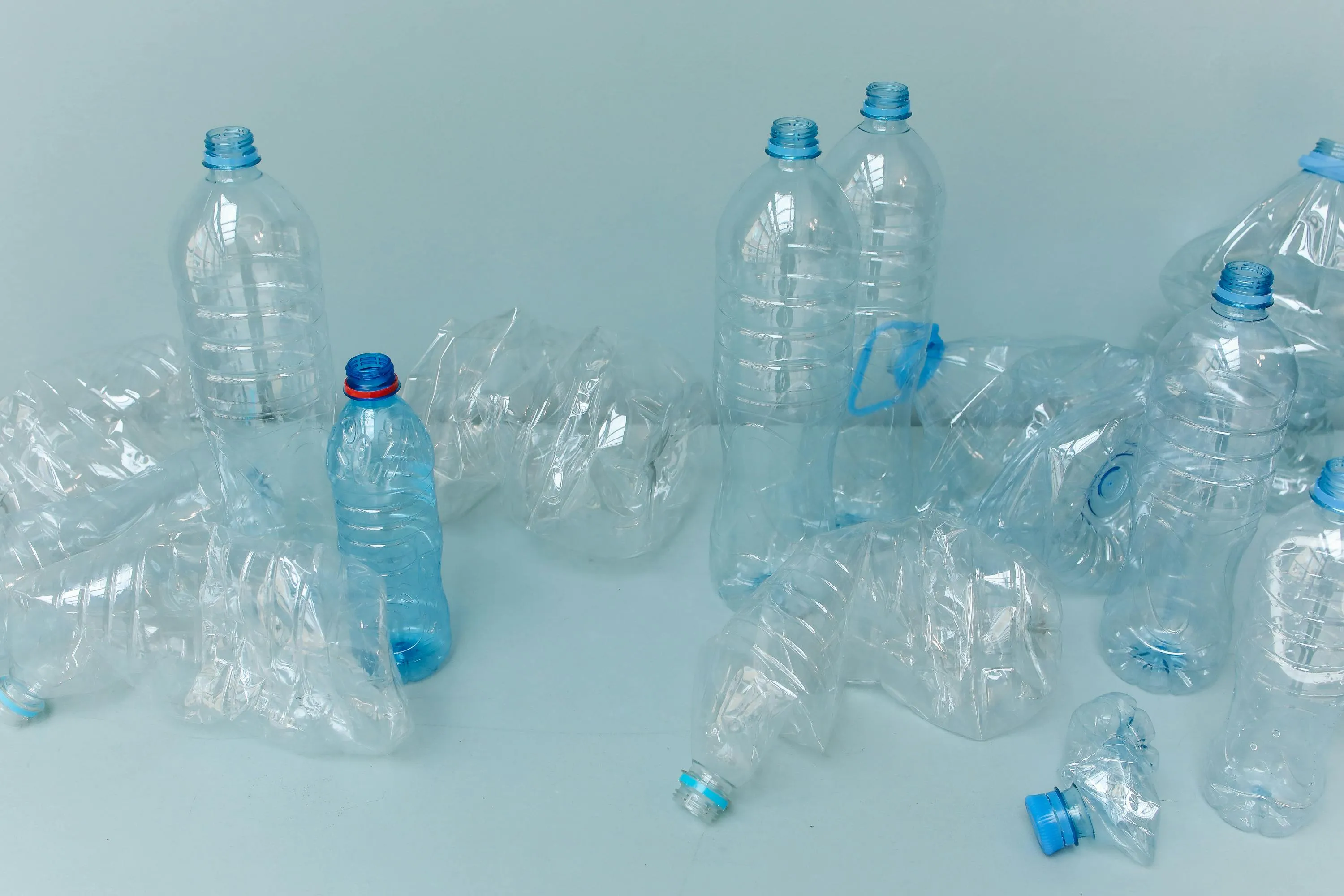 Several empty plastic bottles crushed inward due to changes in air pressure during flight altitude.