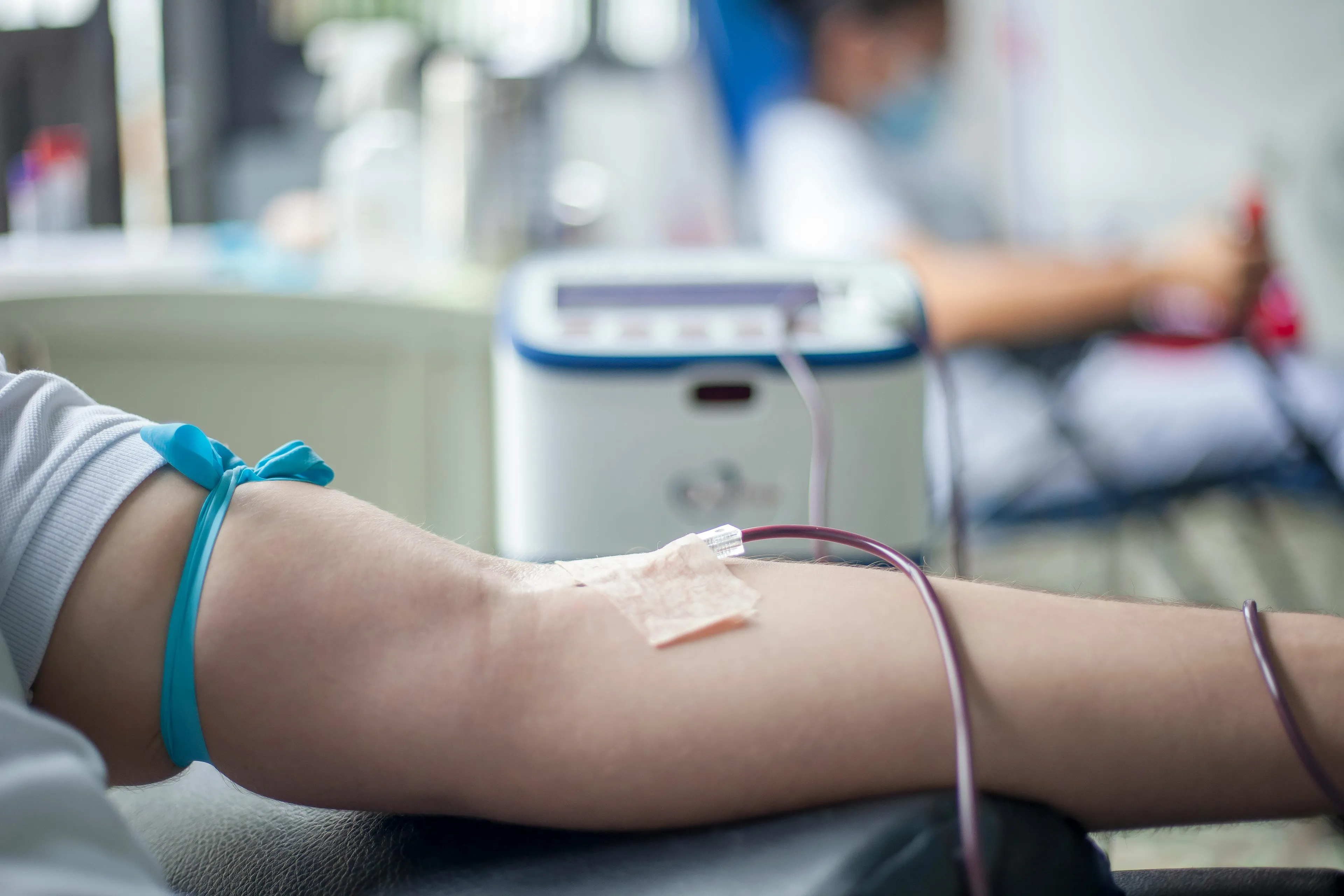 Close-up of arm with blood donation tubing, illustrating science general knowledge about white blood cells.