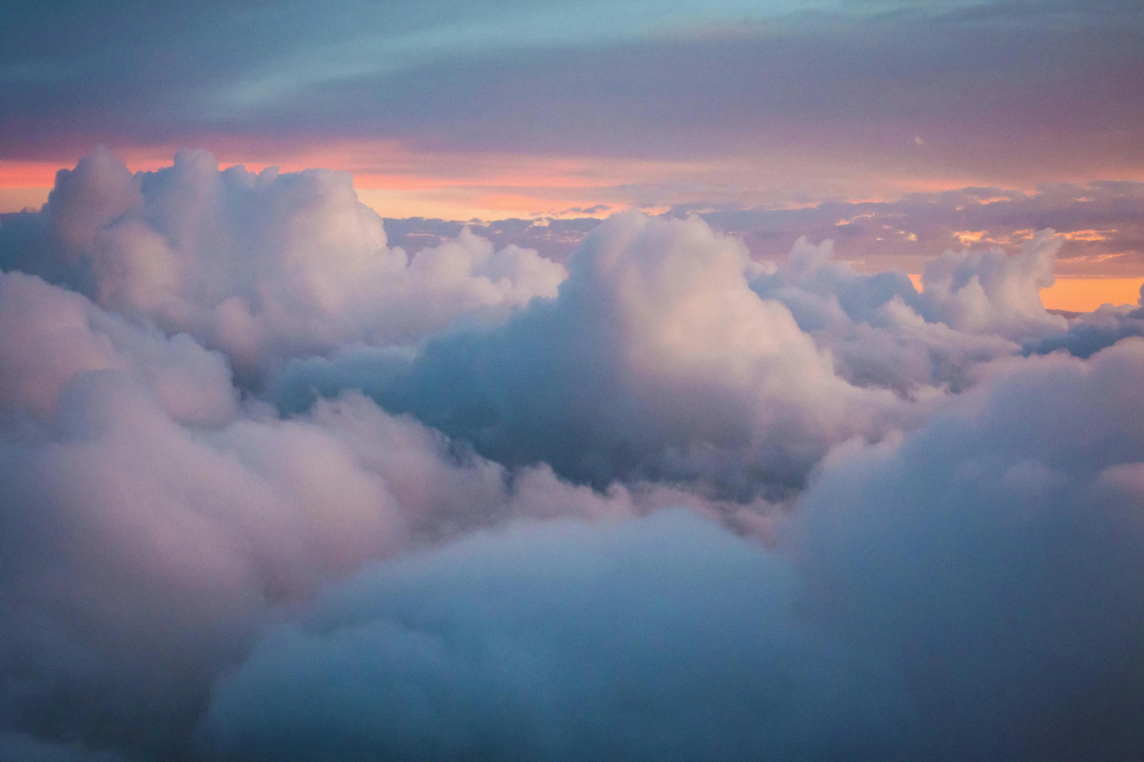 Fluffy clouds forming in the sky at sunset, illustrating the cloud formation process in the water cycle