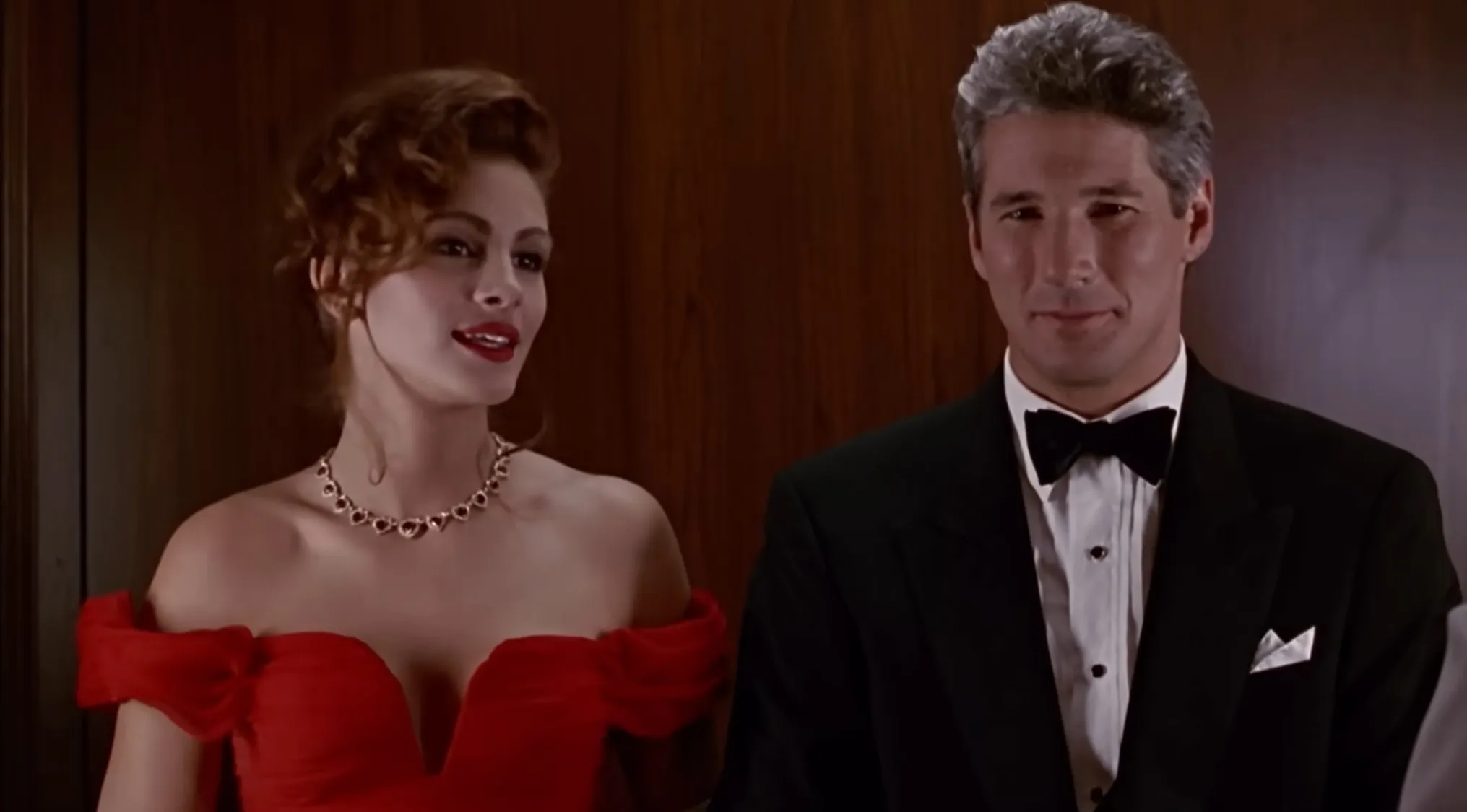 A fictional couples quiz featuring a man in a tuxedo and a woman in a red dress from a film scene.