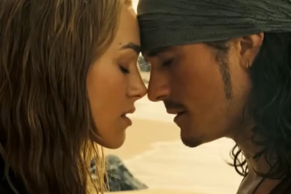 Close-up of two characters from Eyes Wide Shut touching foreheads with eyes closed in an intimate moment near the beach.