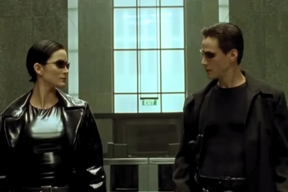 Two characters from Eyes Wide Shut wearing dark sunglasses and black clothing in a modern, minimalistic setting.