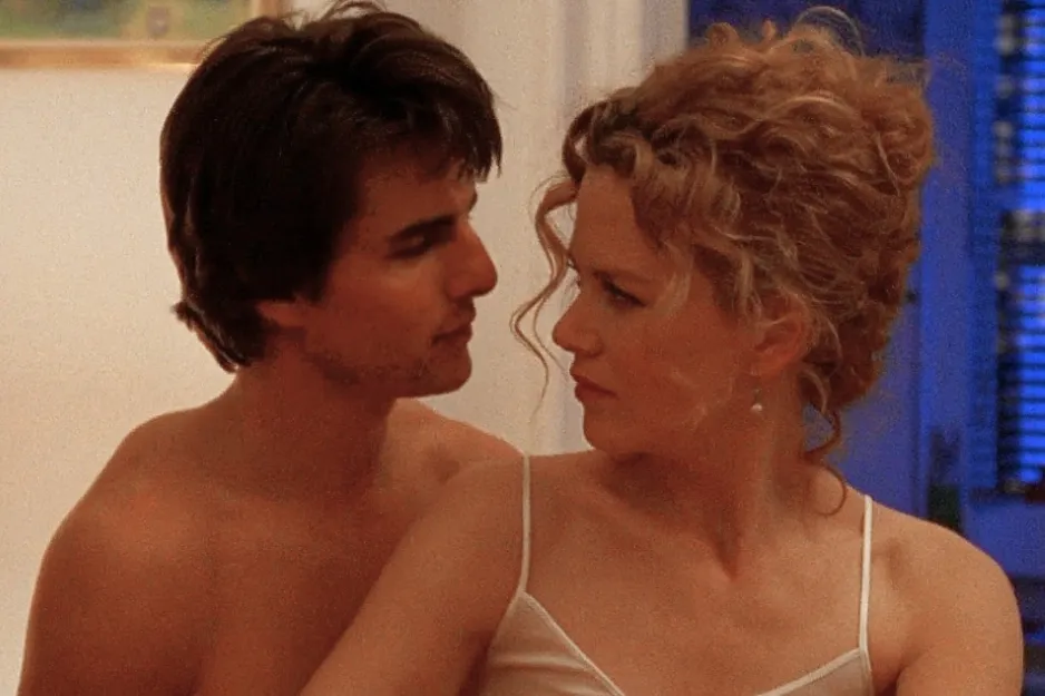 Two main characters from Eyes Wide Shut in an intimate scene, looking deeply into each other's eyes indoors.