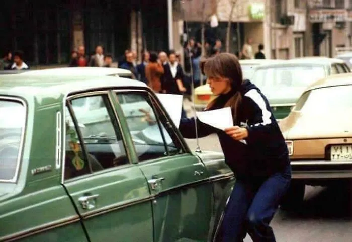 Young Iranian Woman Handing Out Anti-Shah Regime Manifesto In Tehran, 1979