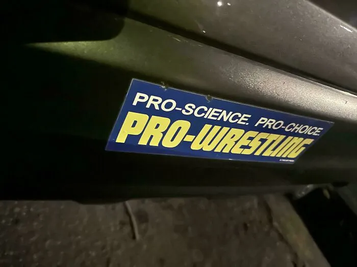 A funny bumper sticker that reads Pro-Science. Pro-Choice. PRO-WRESTLING.