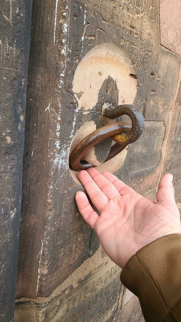 Metal Ring Wearing Into The Sandstone Of The Cathedral In Strasbourg, France