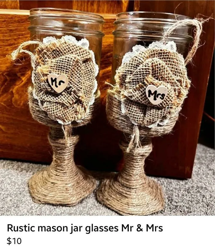 Pair of decorated mason jar wine glasses with burlap flowers, representing questionable DIY projects.