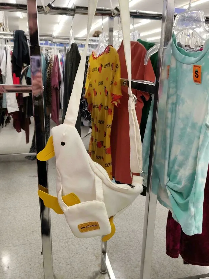 A fun duck-shaped fanny pack hanging on a rack, a great thrift store find and jackpot.