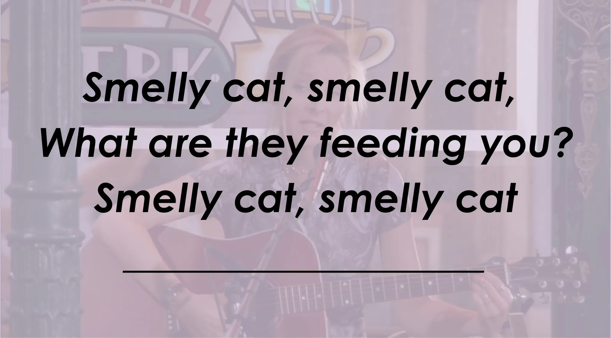 Phoebe performing Smelly Cat song with lyrics displayed, testing ultimate Friends fan knowledge.