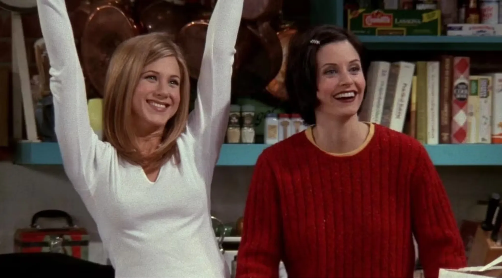 Monica and Rachel celebrating in their apartment kitchen on Friends, key characters in the ultimate Friends fan trivia.